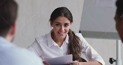 Happy motivated young female team leader holding brainstorming meeting.