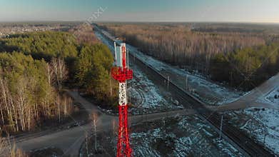 Antenna for 4G or 5G wireless mobile networks near railway tracks against a forest background