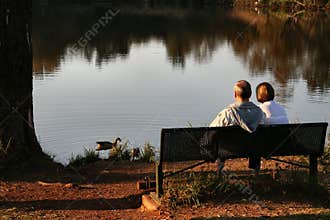 Old couple feeding ducks
