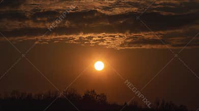 Time lapse amazing sunset with floating clouds going to darkness