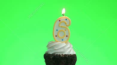 Lighting a number six birthday candle on a delicious cup cake, green screen 6