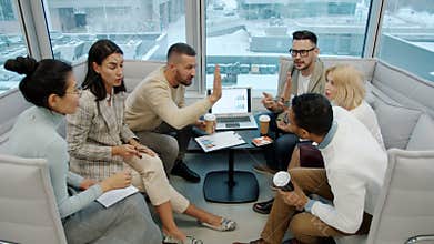 Diverse group of people colleagues talking doing high-five in open space office
