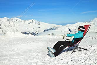 Girl relax in snowy mountains