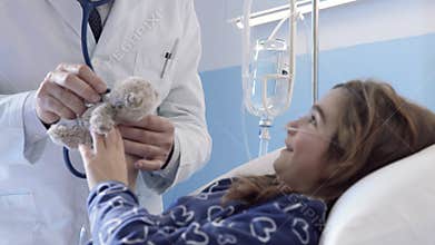 Friendly doctor assisting a patient and playing with her