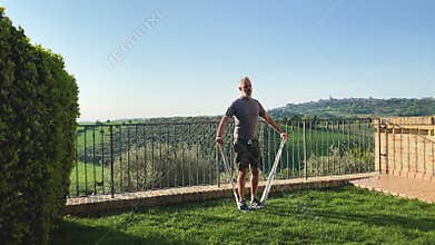 Man doing shoulder exercises with elastic band.