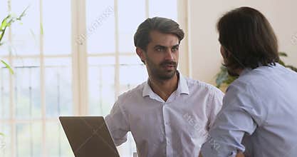 Smiling confident businessman thanking colleague for help.