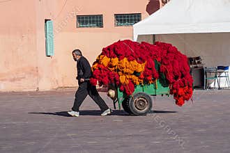 Marrakesh, Morocco - Oct 22, 2019: People at Jemaa el Fna market square with Koutoubia mosque, Marrakesh, Morocco