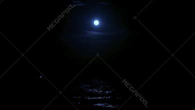 The light of the full moon is reflected in the sea water, the full moon in the sea