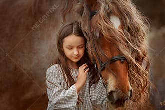 Little girl with palomino miniature horse in summer day