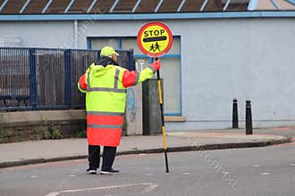 Lollipop Man at a Pedestrian Crossing