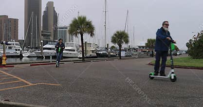Man woman electric scooter Corpus Christi Texas marina 4K