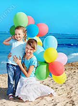 Children playing with balloons at the beach