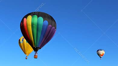 Three Hot Air Balloons Against a Blue Sky