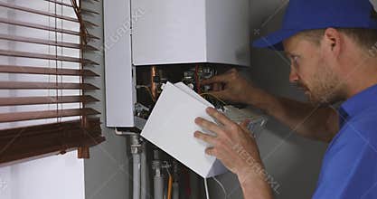 Maintenance and repair service engineer working with house gas heating boiler