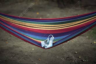 Wedding shoes lie on a hammock