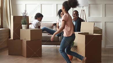 Happy african american family with kids on moving day concept