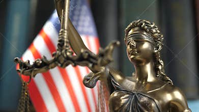 Statue of Lady Justice with Books and USA Flag