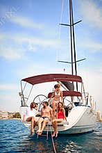 Friends on yacht having fun at summer party on the yacht deck