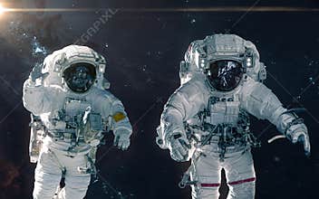 Two astronauts on background of nebulae and star clusters. Deep space landscape. Science fiction