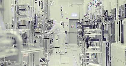 Workers in clean room in a semiconductors manufacturing facility