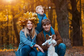 Happy Parents with a child on a walk in the fall. Family