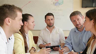 A Team Of Office Employees Discussing On A Creative Project In Boardroom. A group Of Young Member Of Staff Working