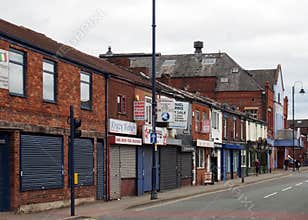 A view of oldham road in ashton under lyne showing the derelict theatre closed shops bars and businesses