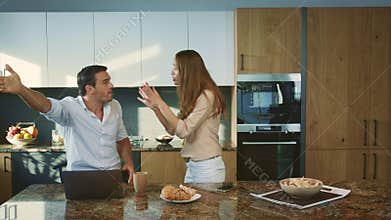 Aggressive man arguing at kitchen. Angry husband having conflict with wife.