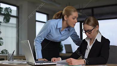 Boss shouting at frustrated employee, bullying and emotional abuse at work