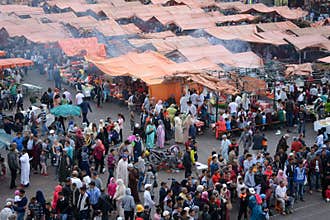 The Jemaa el Fna square, in Marrakech, Morocco, with the smoke of small kitchens, for typical and traditional dishes, celebrating