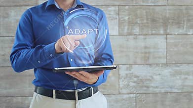 Man uses hologram with text Adapt