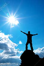 Man on peak of mountain