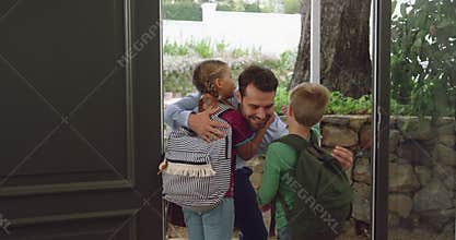 Father embracing his children at door in a comfortable home 4k
