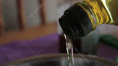 Sunflower oil stream flowing in a bowl