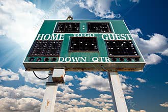 High School Scoreboard Over Blue Sky with Clouds