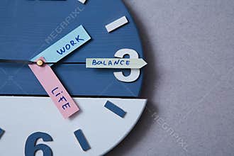 Work life balance choice concept. Clock closeup and arrows telling