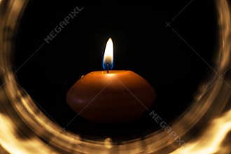 Candle inside light circle in the dark