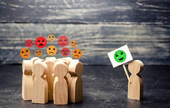 A man with a poster affects an annoyed crowd. Decrease in protest moods, reason and call for humility. Change the bad attitude