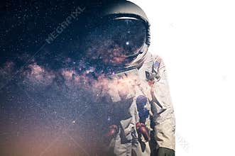 The double exposure image of the astronaut`s suit overlay with the milky way galaxy image. the concept of imagination, technology,