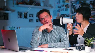 Wife yelling at husband sitting at table, communication problem