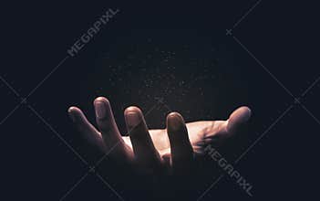 Praying hands with faith in religion and belief in God on blessing background. Power of hope or love and devotion. Magic powder