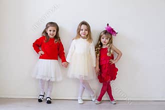 Three little girl girlfriends in red and white dresses
