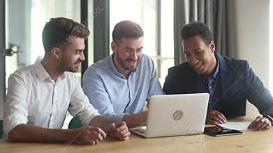 Diverse businessmen working together using apps looking at laptop screen