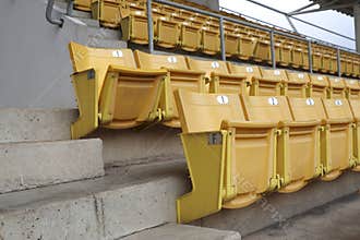 A chair for watching sports on the amphitheater. Chairs lined up in the stands.
