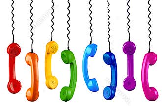Row of colorful rainbow colored old fashioned retro phone reciever with black telephone wire isolated white background, business