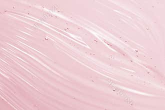 Cosmetic gel background. Face serum, clear beauty cream texture. Pink colored transparent skincare product close-up