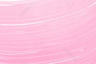 Serum, liquid gel texture. Transparent cosmetic cream background. Clear pink skincare product smudge