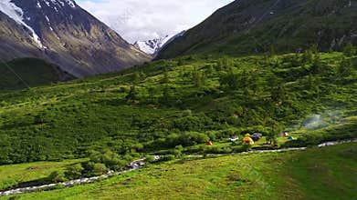 Maelifell camp site people camping with tents near the green mountain in Altai on the sunrise sunset, Icelandic nature