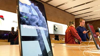 Customers in background and slow focus to iPhone 11 Pro Max