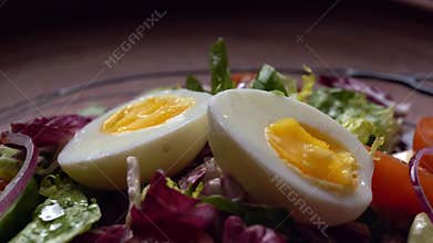 Summer salad of eggs, tomatoes, cucumbers with olive oil and watercress salad.